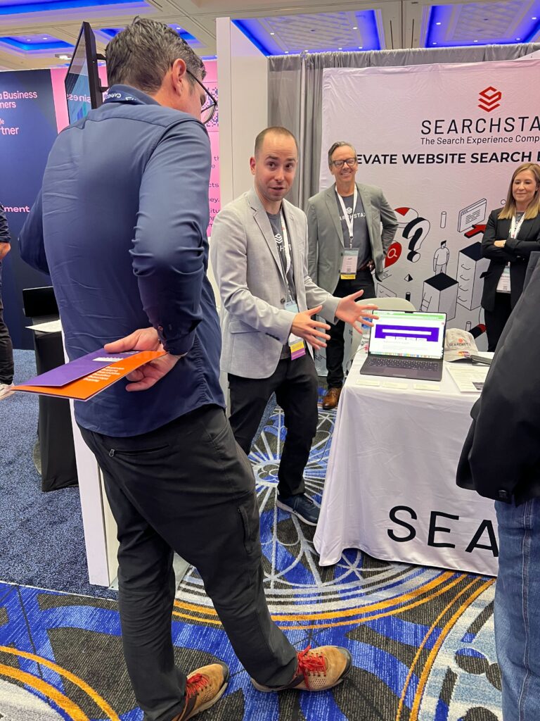 Smart Match Assist practical AI feature for site search launched at the SearchStax booth at AMA 2024